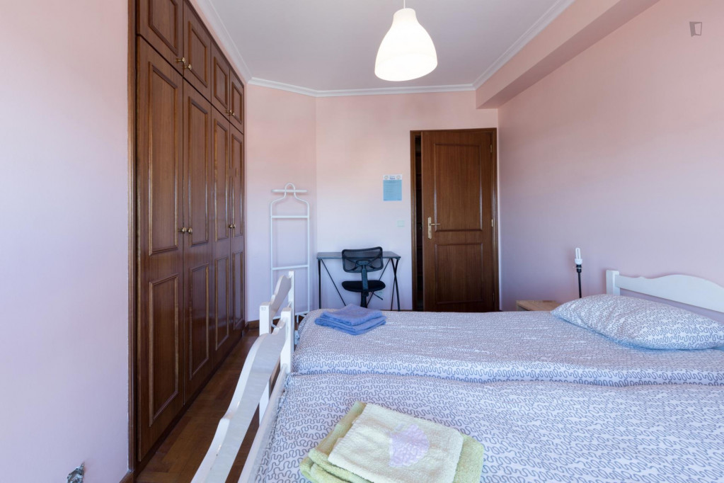 Bright twin bedroom with balcony